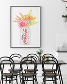 Framed artwork of a Diet Coke can with flowers above a dining table.