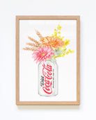 Framed artwork of a Diet Coke can with flowers on a white background
