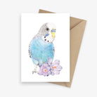 Greeting card featuring a blue budgie with two flowers.