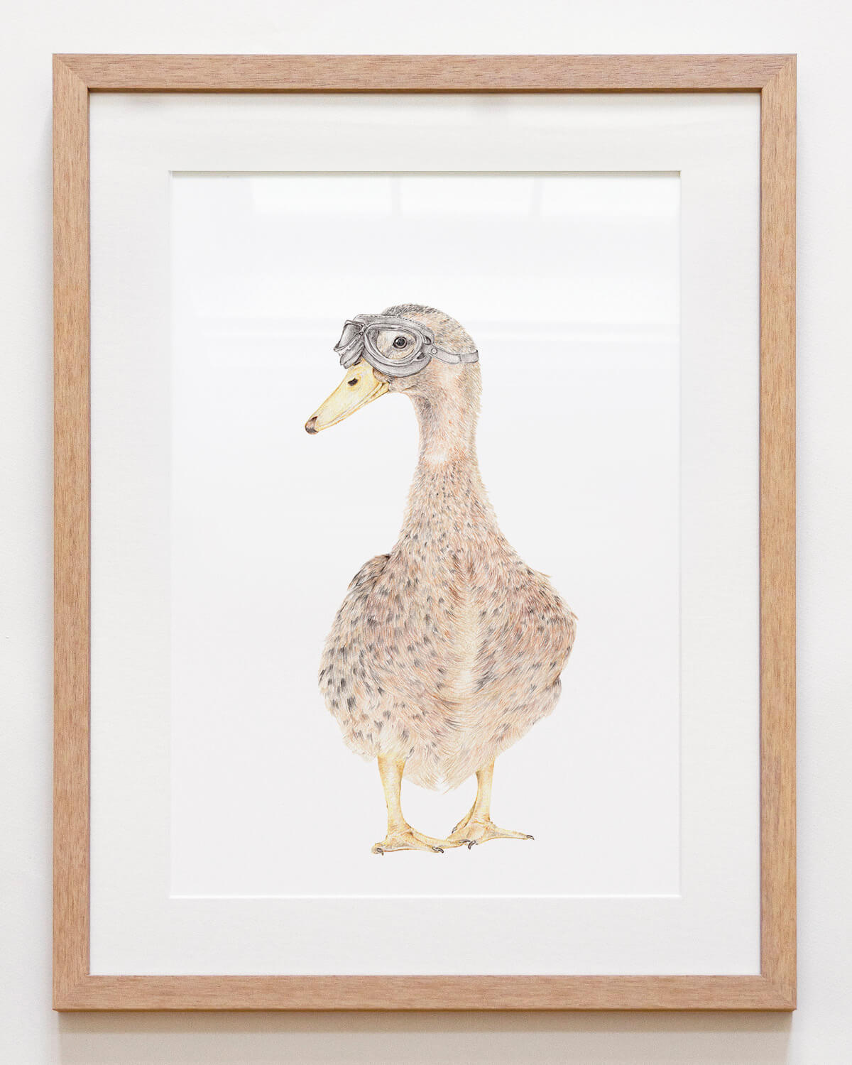 Framed nursery wall art of a duck with goggles